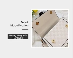 Detail magnification showing the strong gold hardware magnetic buckle on cream handbag