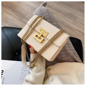 Detail of ivory leather crossbody bag featuring gold double square twist lock and chain