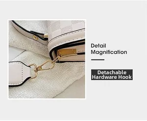 Detail magnification of detachable gold hardware and checkerboard texture on cream bag