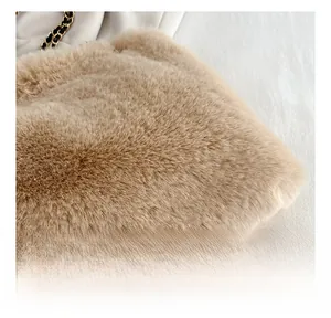 Close-up of premium light brown faux fur texture with elegant gold metal chain strap