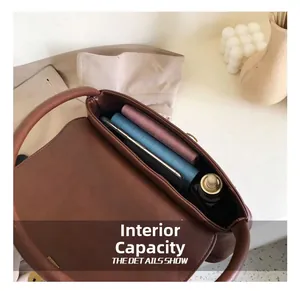Macro view of retro brown leather bag interior showing large capacity for essentials