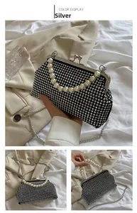 Close-up of sparkling silver rhinestones and elegant white faux pearl handle