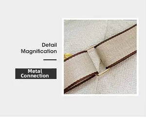 Detailed view of canvas webbing strap with brown trim and gold hardware connection