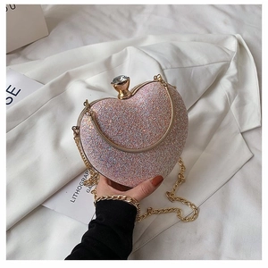 Pink glitter heart-shaped evening clutch bag with gold frame and rhinestone clasp
