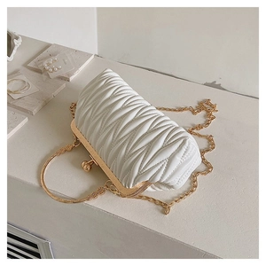 Detail of white quilted cloud bag featuring golden metal handle and fine chain strap
