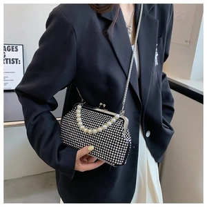Detailed shot of black rhinestone evening bag with pearl handle and silver chain strap