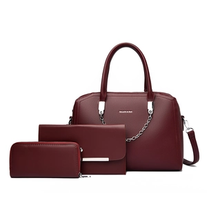 Three-piece burgundy faux leather handbag set with large tote, clutch and wallet