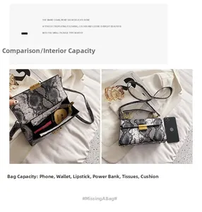 Macro view of snakeskin crossbody bag showing interior capacity for phone and makeup