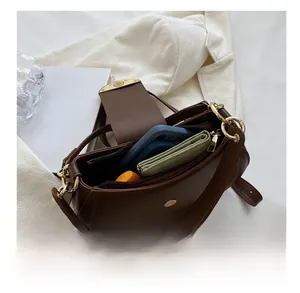 Top view of brown leather saddle bag interior showing space for phone and wallet