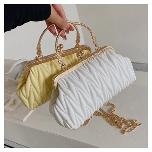 Close-up of quilted leather crossbody bags with vintage gold frame and chain strap