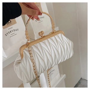 Detail of white pleated cloud bag with gold metal handle and vintage clasp closure