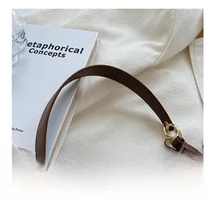 Detail of vintage brown shoulder bag with smooth leather finish and gold ring hardware