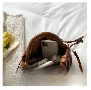 Interior view showing the storage capacity of this brown pleated pouch bag