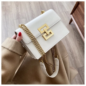Detail of white leather crossbody bag with golden geometric lock and metal chain strap