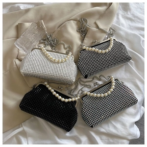 Macro view of four elegant rhinestone evening bags with pearl handles and chain straps