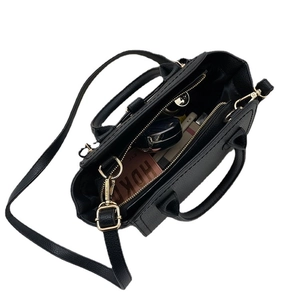 Black textured leather satchel bag showing spacious interior with crossbody strap