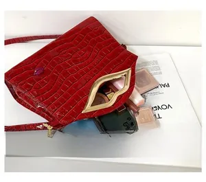 Vue intérieure du sac bandoulière rouge effet crocodile montrant l'espace pour maquillage