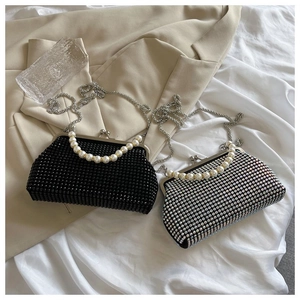 Detail of luxury rhinestone clutch bags with pearl handles and silver metal chains