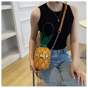 Détail du sac bandoulière ananas en cuir PU matelassé jaune avec des clous dorés
