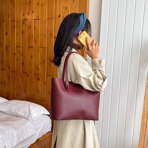 Stylish burgundy leather tote bag with long shoulder straps for women's daily commute