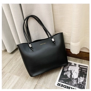 Chic black faux leather tote bag with Forever Young gold lettering and slim shoulder straps