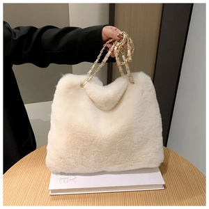 Chic cream white faux fur tote bag with golden metal chain straps and soft plush texture