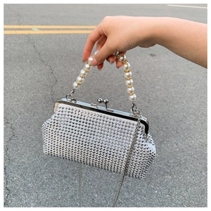 Detail of silver rhinestone evening bag with large pearl handle and metal chain
