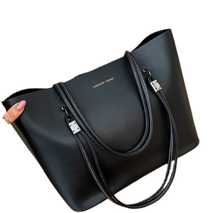 Large black tote bag with white contrast stitching and Forever Young gold lettering