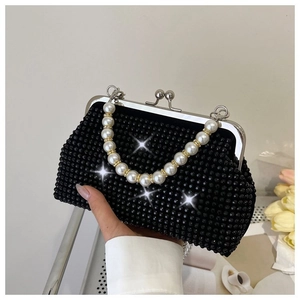 Detail view of black beaded evening clutch bag with pearl handle and silver clasp