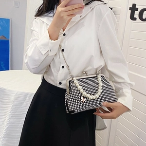 Sparkly rhinestone handbag with pearl top handle and elegant butterfly charm