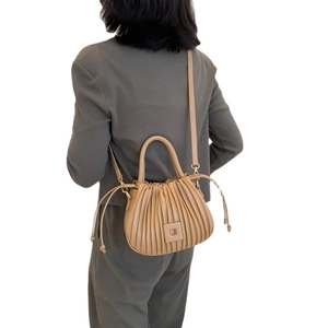 Pleated khaki crossbody handbag for women featuring a top handle and drawstring details