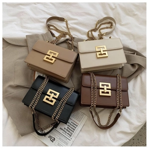 Flat lay of small square chain bags in khaki, beige, black, and coffee with gold clasps