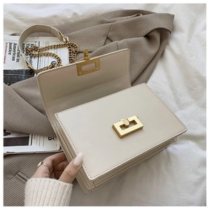 Top view of cream leather flap crossbody bag with gold mechanical lock and chain strap