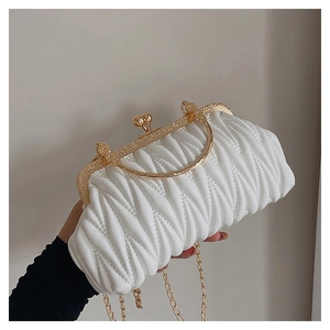 Detail of white pleated clutch with gold clasp, metal handle and delicate chain strap
