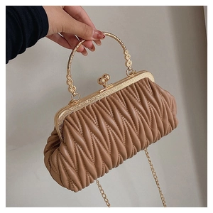 Detailed view of dark apricot pleated leather bag with gold floral handle and ball clasp