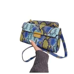 Women's trendy snake print crossbody bag with blue and yellow patterns and gold clasp