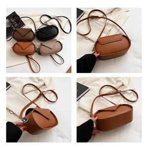 Detail view of mini oval crossbody bags with stitching and adjustable straps in four colors