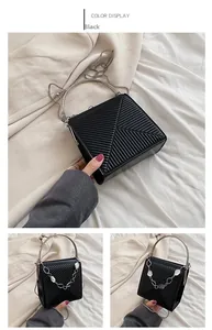 Black handbag with geometric diagonal embossing and round silver metal handles