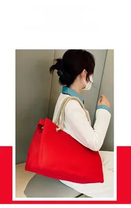 Close-up of red large canvas tote bag with thick rope handles for daily commute