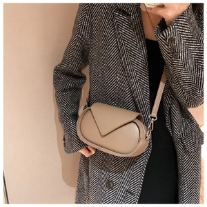 French style khaki crossbody bag styled with a patterned coat in a mirror selfie