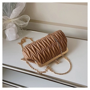 Detail of camel leather cloud bag with pleated design and golden round handle
