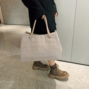 Modern casual canvas tote bag featuring thick rope handles and a stylish neutral weave design
