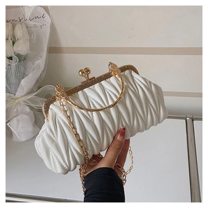 Close-up of white pleated cloud bag with vintage gold clasp and detachable chain strap