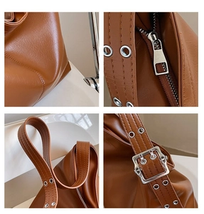 Détails du sac cabas en cuir marron avec œillets argentés et fermeture à glissière