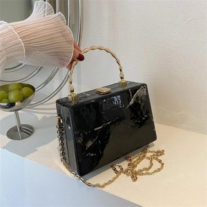 Elegant marble pattern crossbody bag with gold bamboo handle and fine chain strap