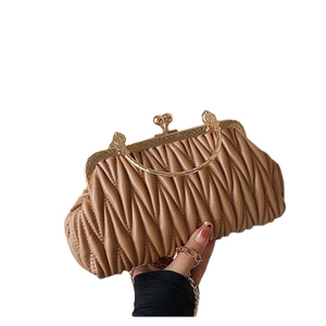 Quilted beige pleated shoulder bag with golden round handle and vintage kiss lock clasp