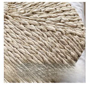 Close-up of high-quality woven texture on a beige handmade straw handbag for women