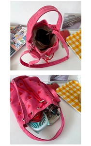Interior view of pink velvet bucket bag showing capacity for phone and daily items