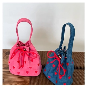 Pink and denim bucket bags with red heart embroidery and drawstring closure