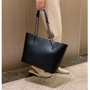 Classic black leather tote bag with stylish chain shoulder straps for everyday office commute